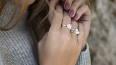 Snowflake ring and several pearl rings on model