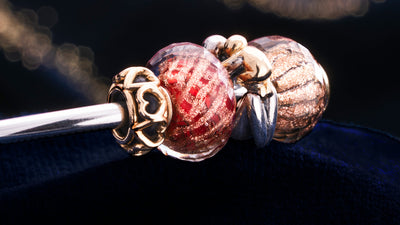 Trollbeads bangle with gold heart spacer, glittery glass beads and a maternity silver with gold bead 
